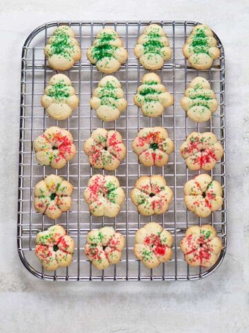 Gluten-free spritz cookies on wire rack.