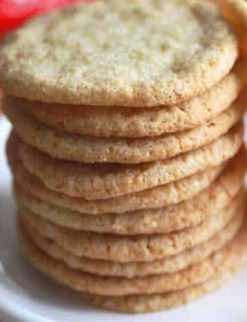 Stack of gluten-free sugar cookies on a white plate.