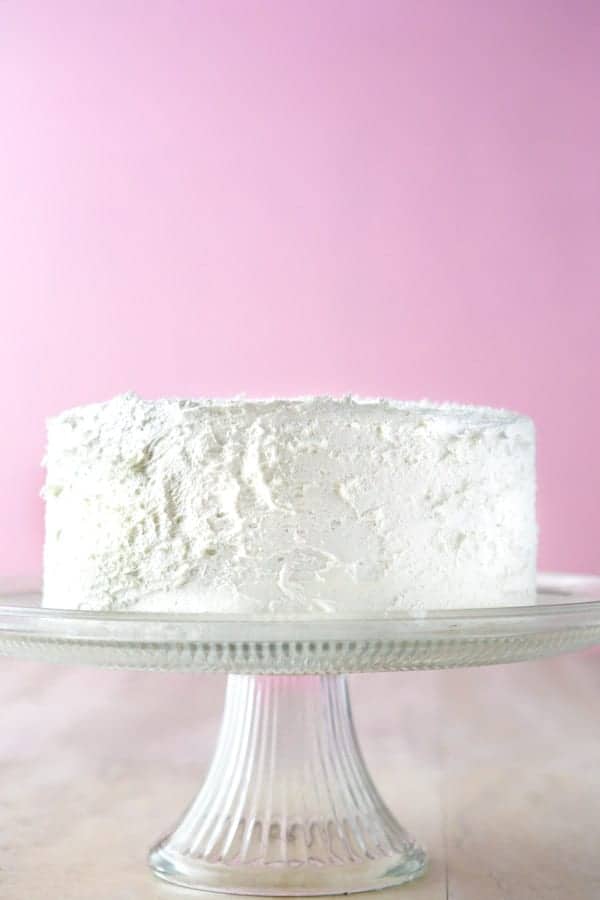 Gluten-Free white cake on cake stand.