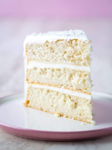 Slice of gluten-free white cake on plate.