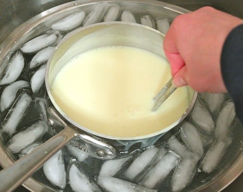 Cooling a pot of eggnog in an ice-water bath.