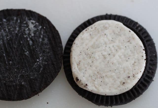 Gluten-free sandwich cookie spilt open to show white filling.