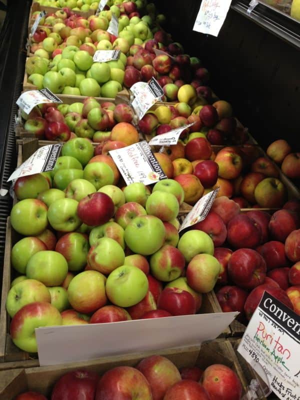 Bins of apples for sale at the market.