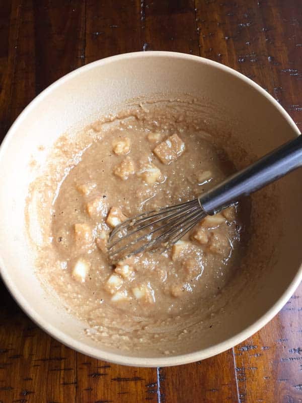 Paleo apple muffin batter in a brown bowl.