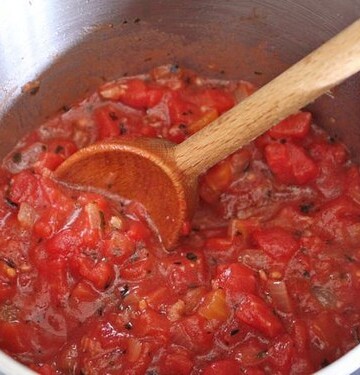 Pizza sauce cooking in pot.