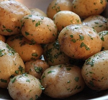 Steamed potatoes coated in butter and herbs.