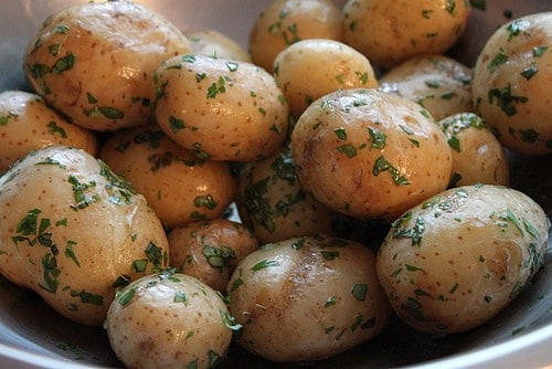 Steamed potatoes coated in butter and herbs.