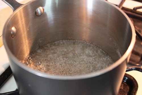 Cooking sugar syrup for caramel sauce.