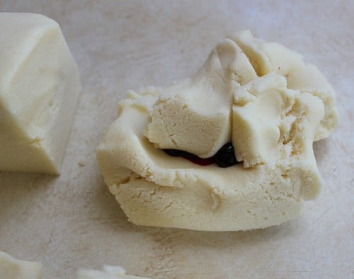 Gluten-free cookie dough about to be kneaded to incorporate red dye.