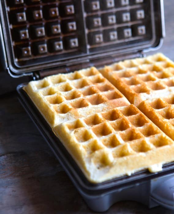 Gluten-free waffles in a waffle iron.