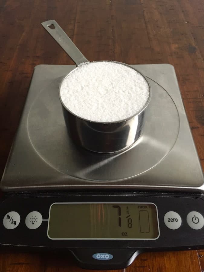 Granulated sugar on a digital scale. Display reads 7 1/8 ounces.